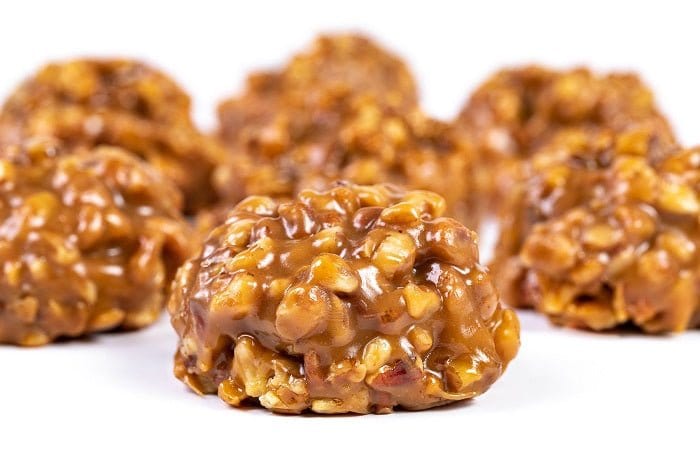 Millican Pecan Chewy Pecan Pralines in a gift box, showcasing golden, caramelized pecan treats with a glossy finish.