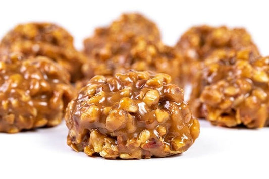 Millican Pecan Chewy Pecan Pralines in a gift box, showcasing golden, caramelized pecan treats with a glossy finish.