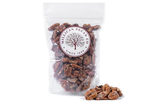 Millican Pecan cinnamon candied pecans in a 12oz bag, showing shiny, caramelized pecans coated with cinnamon flavor.