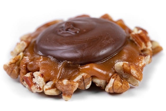 Dark chocolate Caramillicans pecan treats by Millican Pecan, individually wrapped with dark chocolate coating and caramel filling.