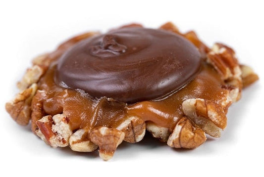 Dark chocolate Caramillicans pecan treats by Millican Pecan, individually wrapped with dark chocolate coating and caramel filling.