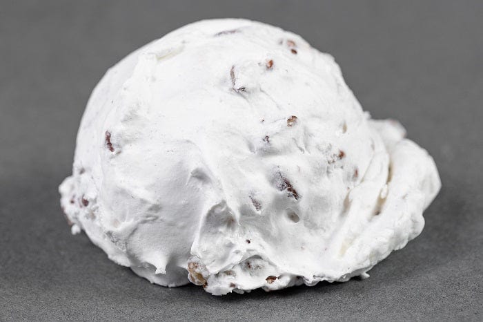 Individual Millican Pecan Divinity treat, creamy pecan candy with a smooth texture and nutty flavor.