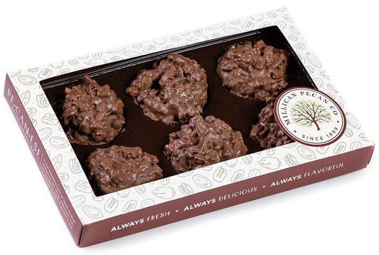 Millican Pecan milk chocolate pecan clusters in an 8oz gift box, featuring crunchy pecans coated in smooth milk chocolate.