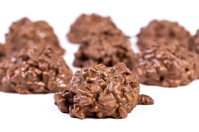 Milk chocolate pecan clusters from Millican Pecan in a gift box, showcasing rich chocolate coating and crunchy pecans.