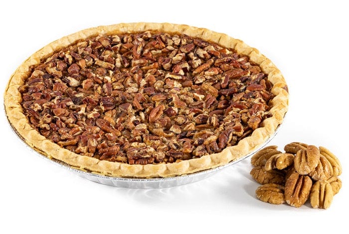 Delicious Millican Pecan Texas Pecan Pie with a golden crust and rich pecan filling on a plate.