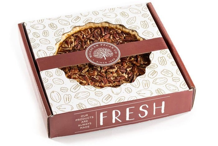 Boxed Millican Pecan Pecan Pie with golden-brown crust and glazed pecans, perfect for dessert.