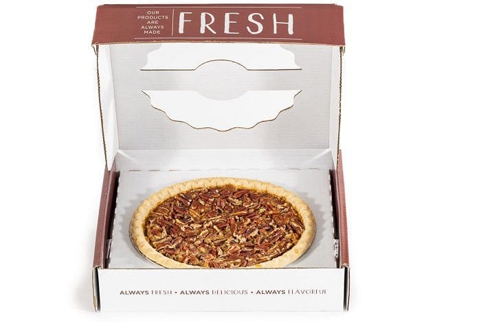 Open box of Millican Pecan Texas Southern Pecan Pie showing a rich, sliced pecan pie with golden crust and caramelized pecans.