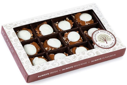 White chocolate Caramillicans pecan treats in a gift box by Millican Pecan, featuring white chocolate coating and crunchy pecan centers.