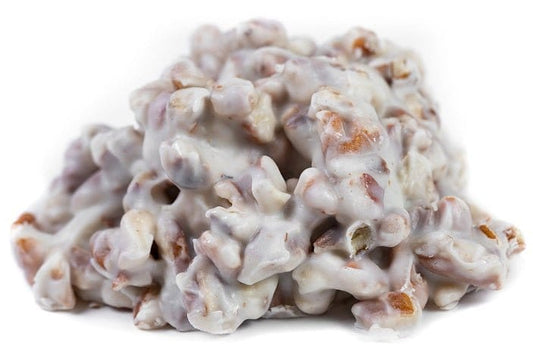 Millican Pecan white chocolate pecan cluster, individual pecan treat with white chocolate coating and crunchy pecans.