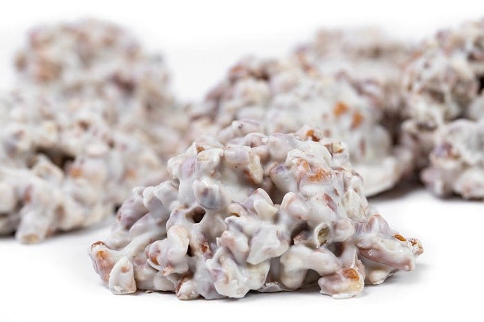 Millican Pecan White Chocolate Pecan Clusters in a gift box, featuring crunchy pecans coated in creamy white chocolate.