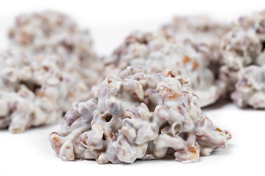 Millican Pecan white chocolate pecan cluster, a delicious individual pecan treat with white chocolate coating and crunchy pecans.