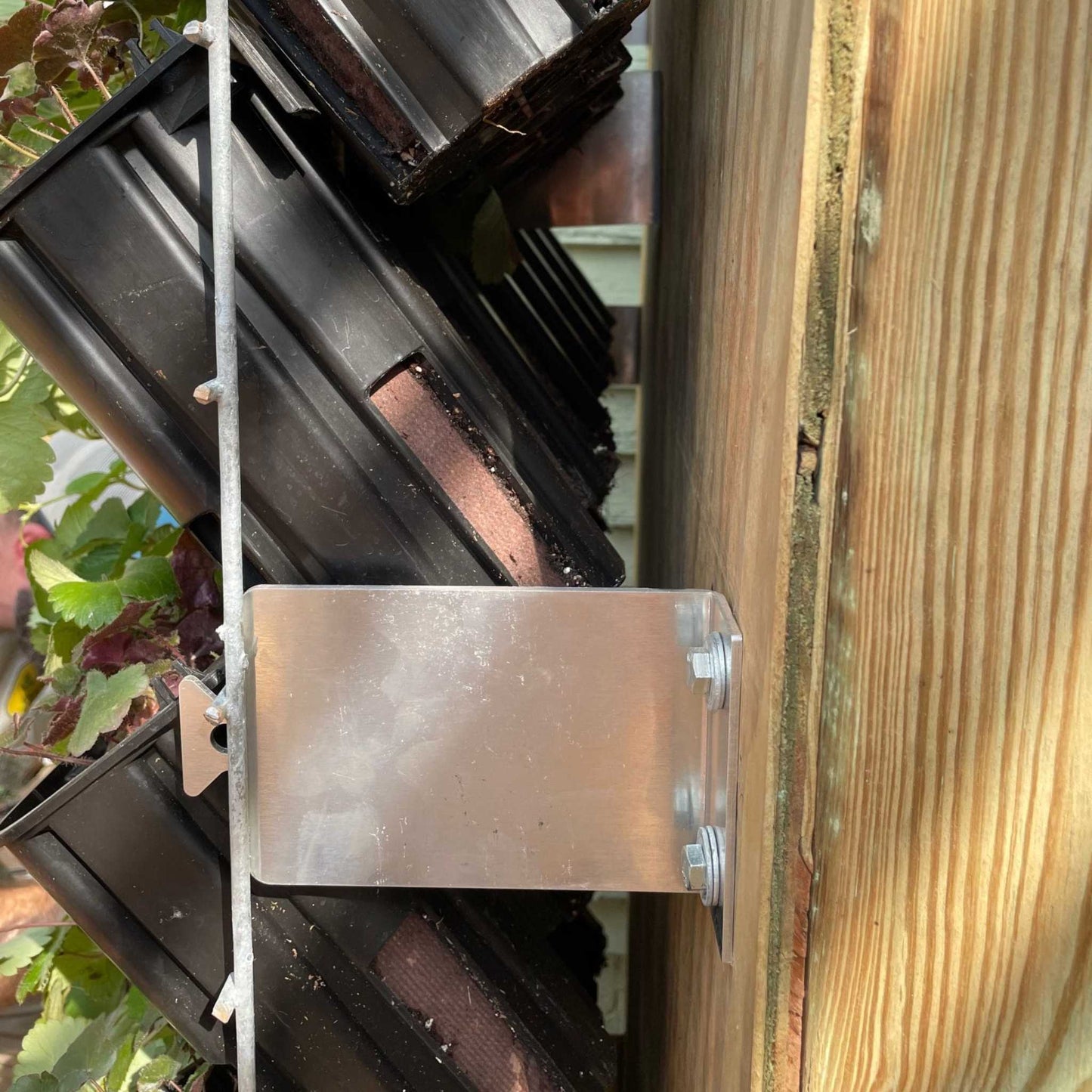 Bootstrap Farmer mounting cleats installed on a surface for secure attachment of garden or farm equipment.