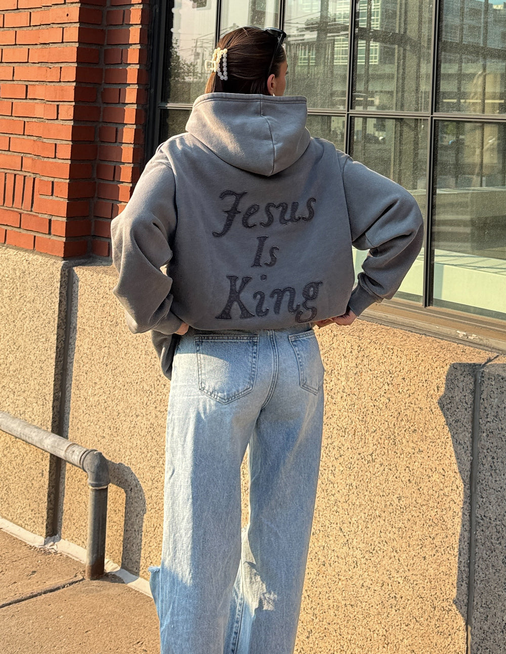 Unisex hoodie by Elevated Faith with "Not Sorry Jesus Is King" printed design, featuring a comfortable fit and casual style.