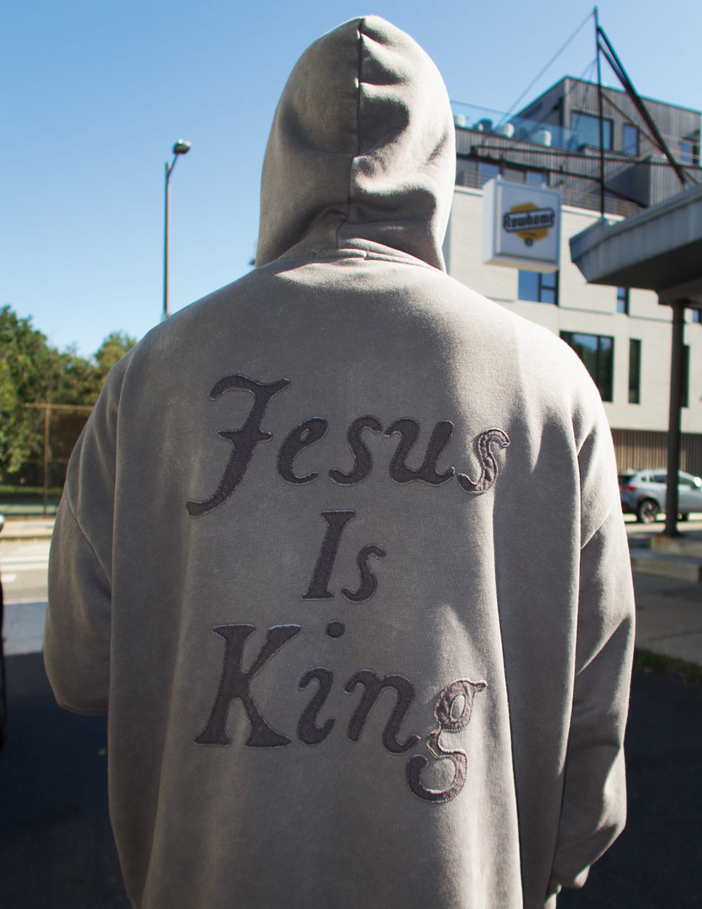 Unisex hoodie by Elevated Faith featuring "Not Sorry Jesus Is King" text in bold black on a soft fabric hoodie.