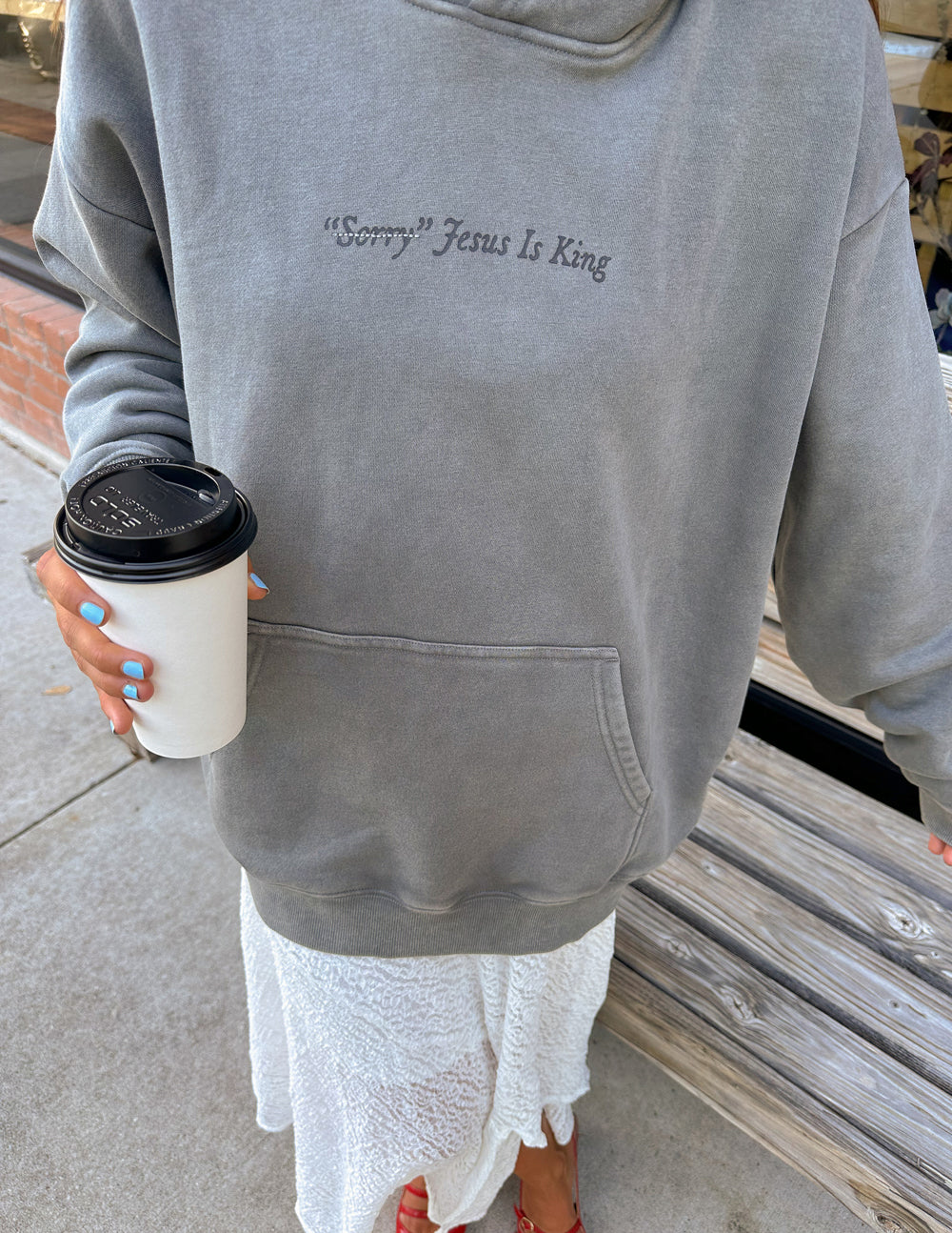 Unisex hoodie by Elevated Faith featuring "Not Sorry Jesus Is King" graphic, casual fit, in black fabric.