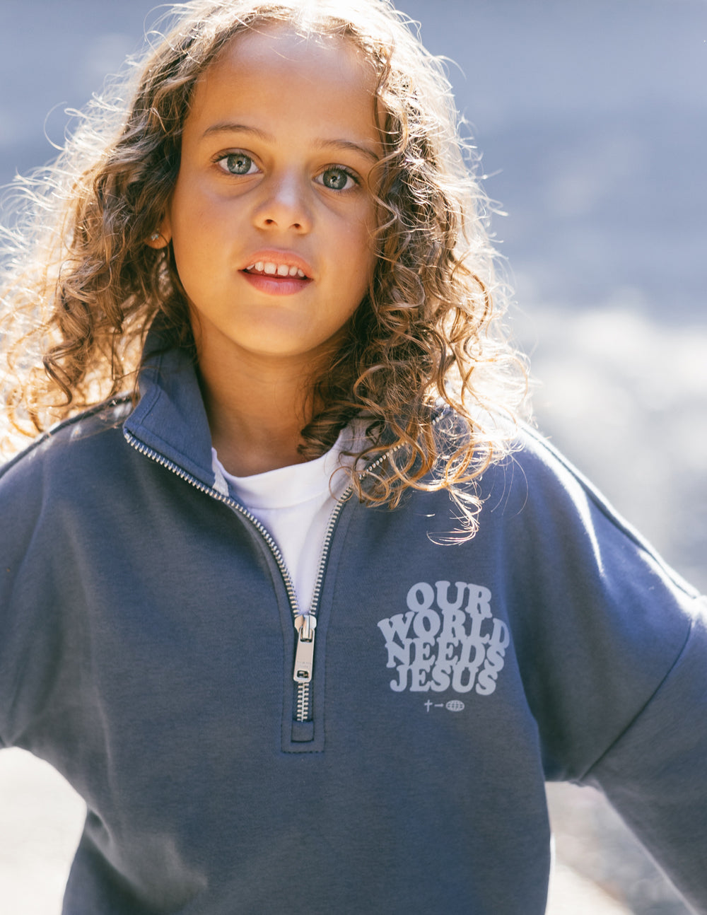 Kids jacket by Elevated Faith with "Our World Needs Jesus" half-zip design, soft fabric, and comfortable fit for children.