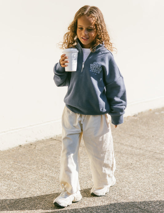 Kids jacket by Elevated Faith featuring "Our World Needs Jesus" print in a half-zip style, suitable for children.