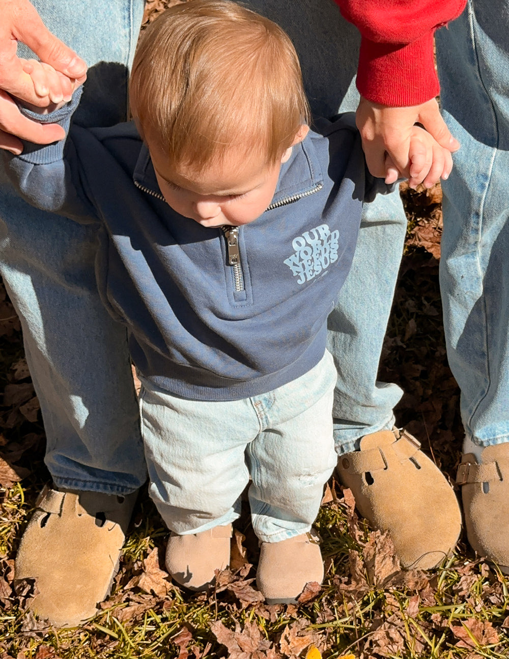 Kids' half-zip jacket by Elevated Faith featuring "Our World Needs Jesus" print, made for children to wear comfortably.
