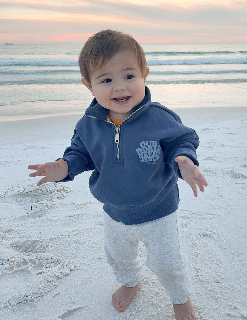 Kids jacket by Elevated Faith featuring "Our World Needs Jesus" slogan on a half-zip design, suitable for children.