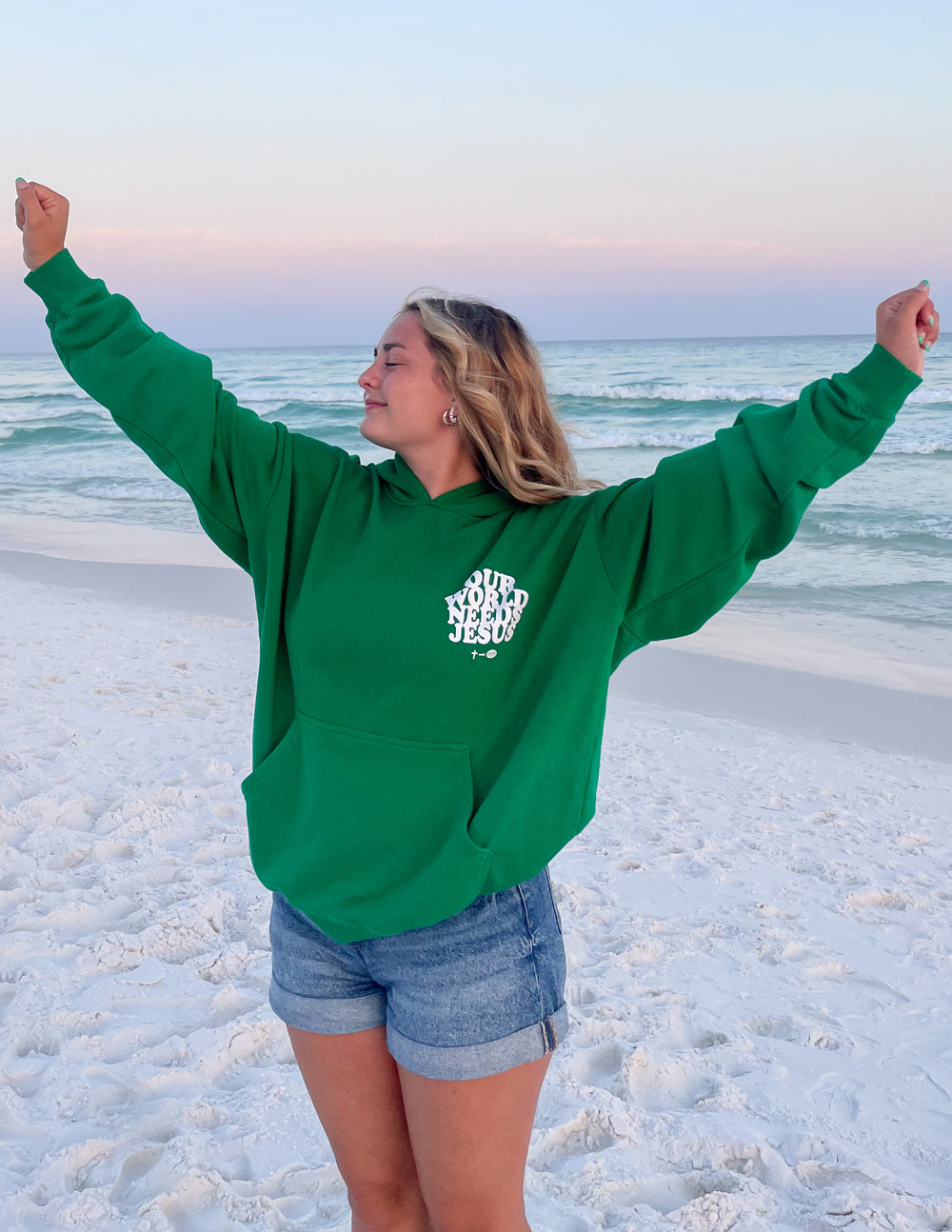 Unisex hoodie by Elevated Faith featuring "Our World Needs Jesus" text, in black with front design and soft fabric.
