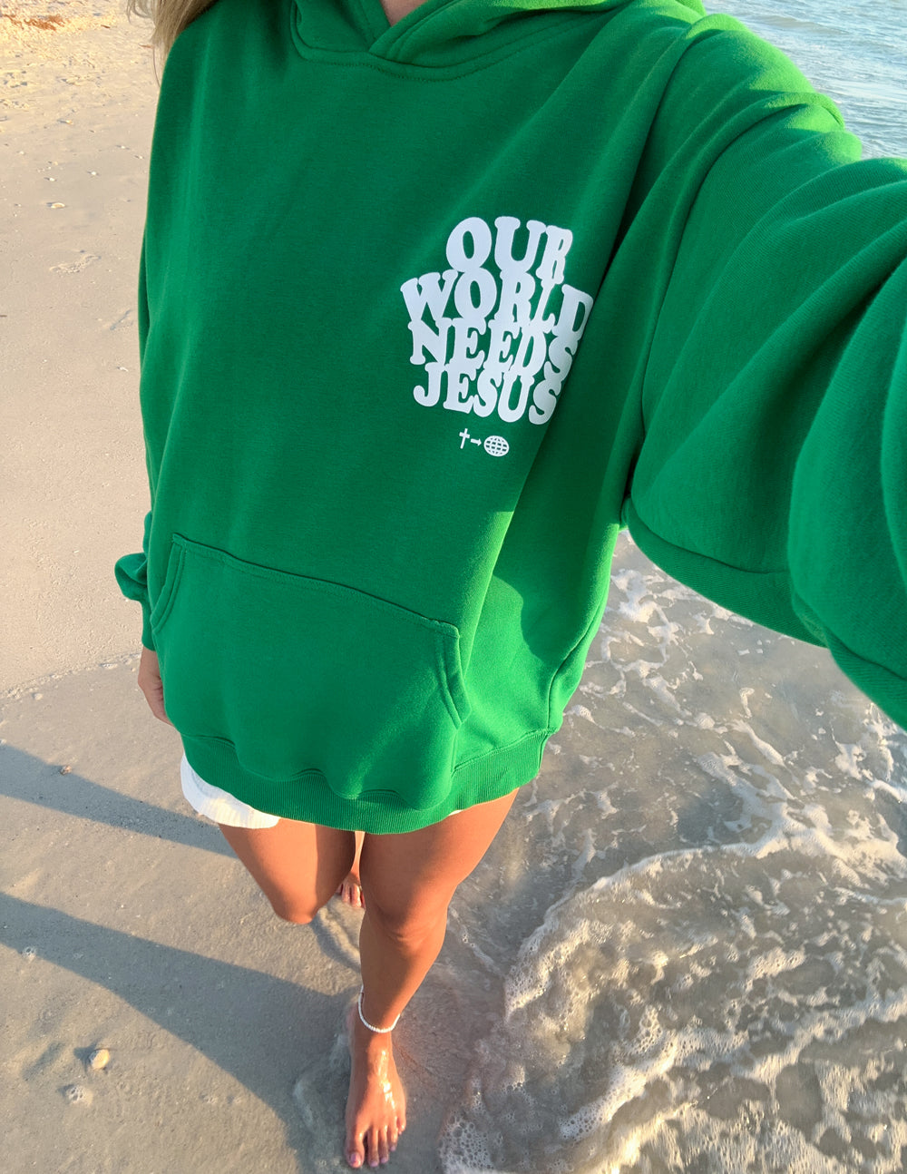 Unisex hoodie from Elevated Faith with "Our World Needs Jesus" printed design on front, soft fabric and casual fit.