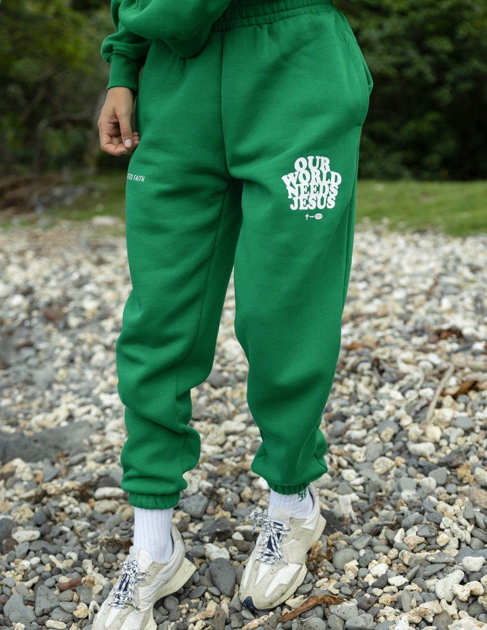 Unisex sweatpants by Elevated Faith featuring "Our World Needs Jesus" printed text, casual fit with elastic waistband and cuffs.