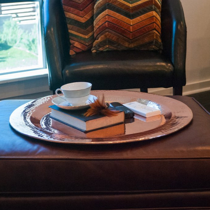 Copper Thessaly round platter by Sertodo, showcasing a polished, round serving plate with a smooth, shiny copper finish.