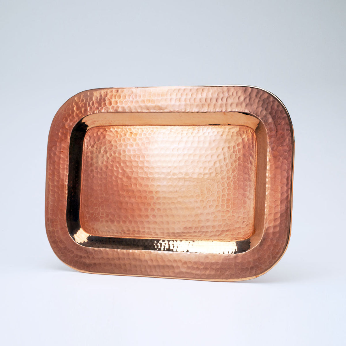 Small copper Thessaly rectangle platter by Sertodo, featuring a handcrafted rectangular design for serving food.