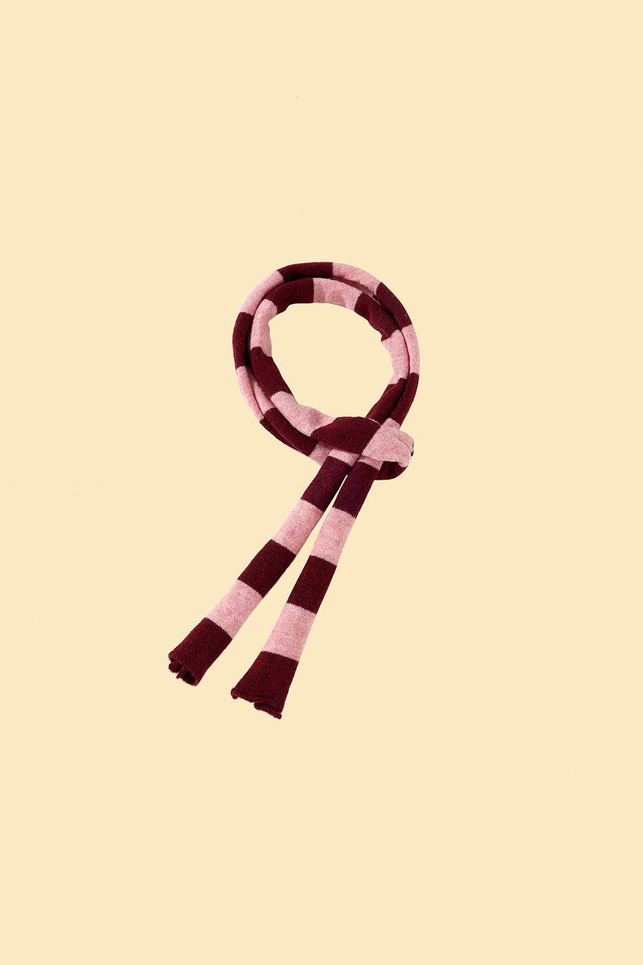 Pink and white striped BarkBarkBaby Rosé Bliss Thin Useless scarf draped over a matching sweater, showcasing lightweight, cozy knit fabric.