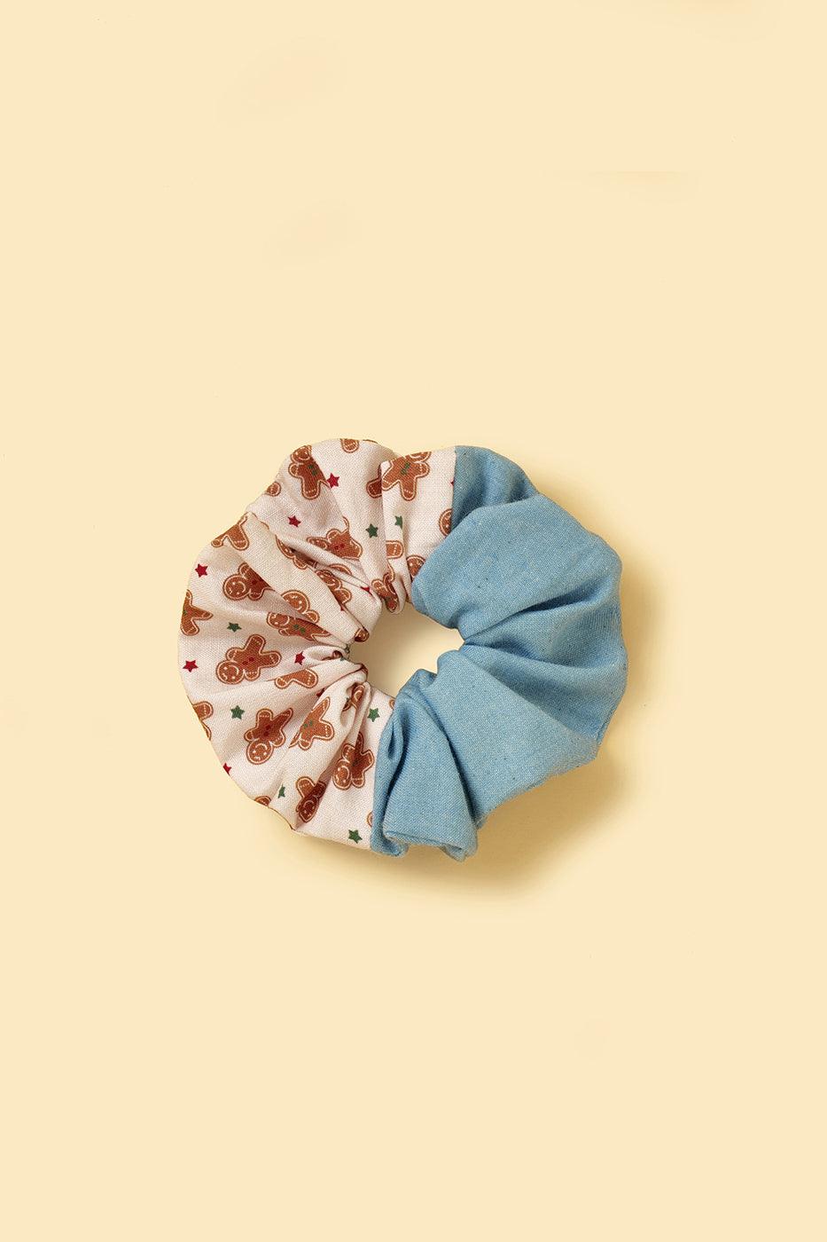 Joy handmade gingerbread man scrunchie by BarkBarkBaby featuring a festive gingerbread cookie design with colorful accents.