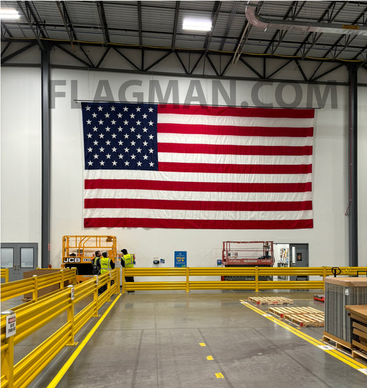 Nylon American flag wall-mounted WallSafe™ by Flagman of America with reinforced grommets, made in the USA, hanging on a wall.