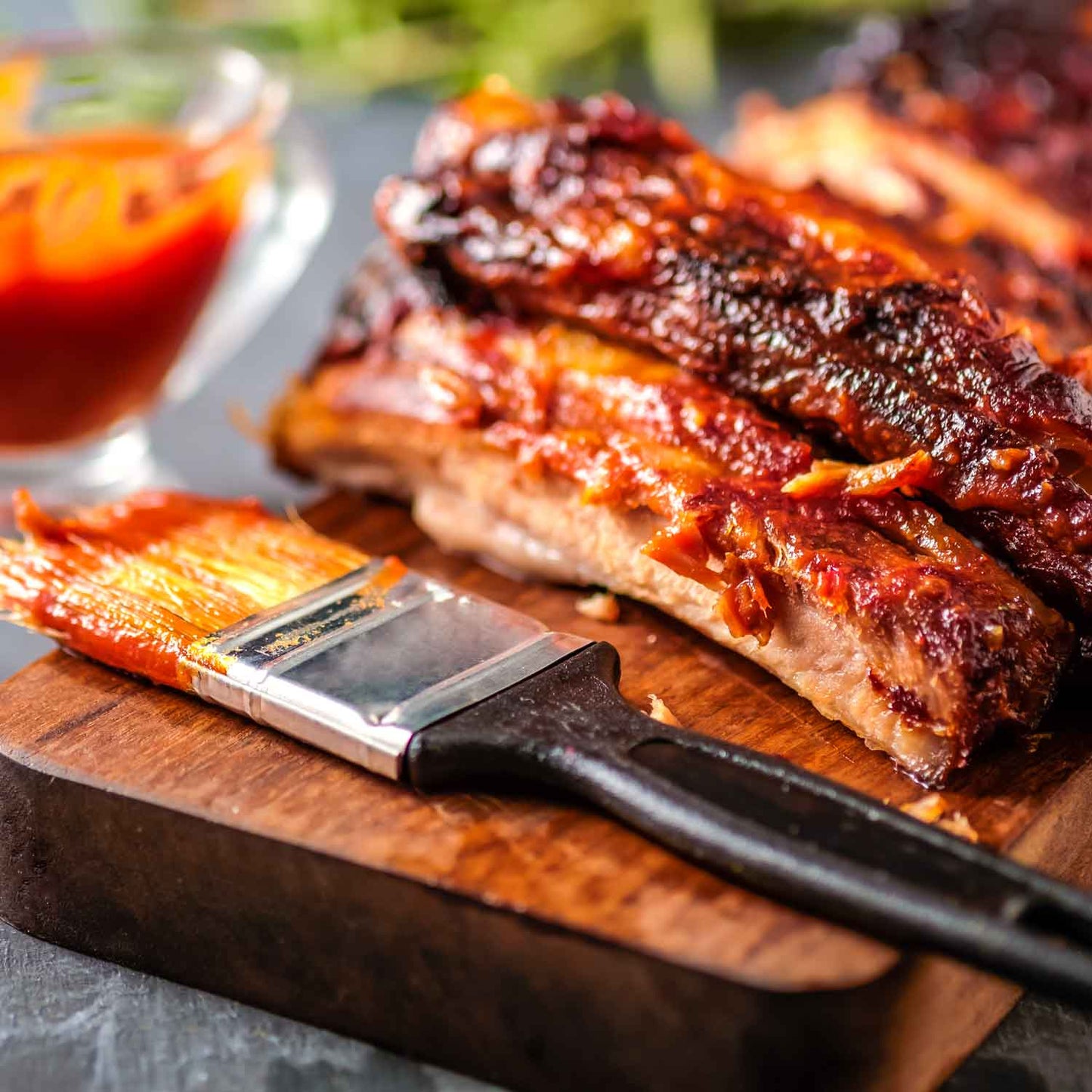 Juicy Peach Sriracha Baby Back BBQ Ribs by Pig of the Month BBQ, glazed with flavorful sauce, ready to serve.