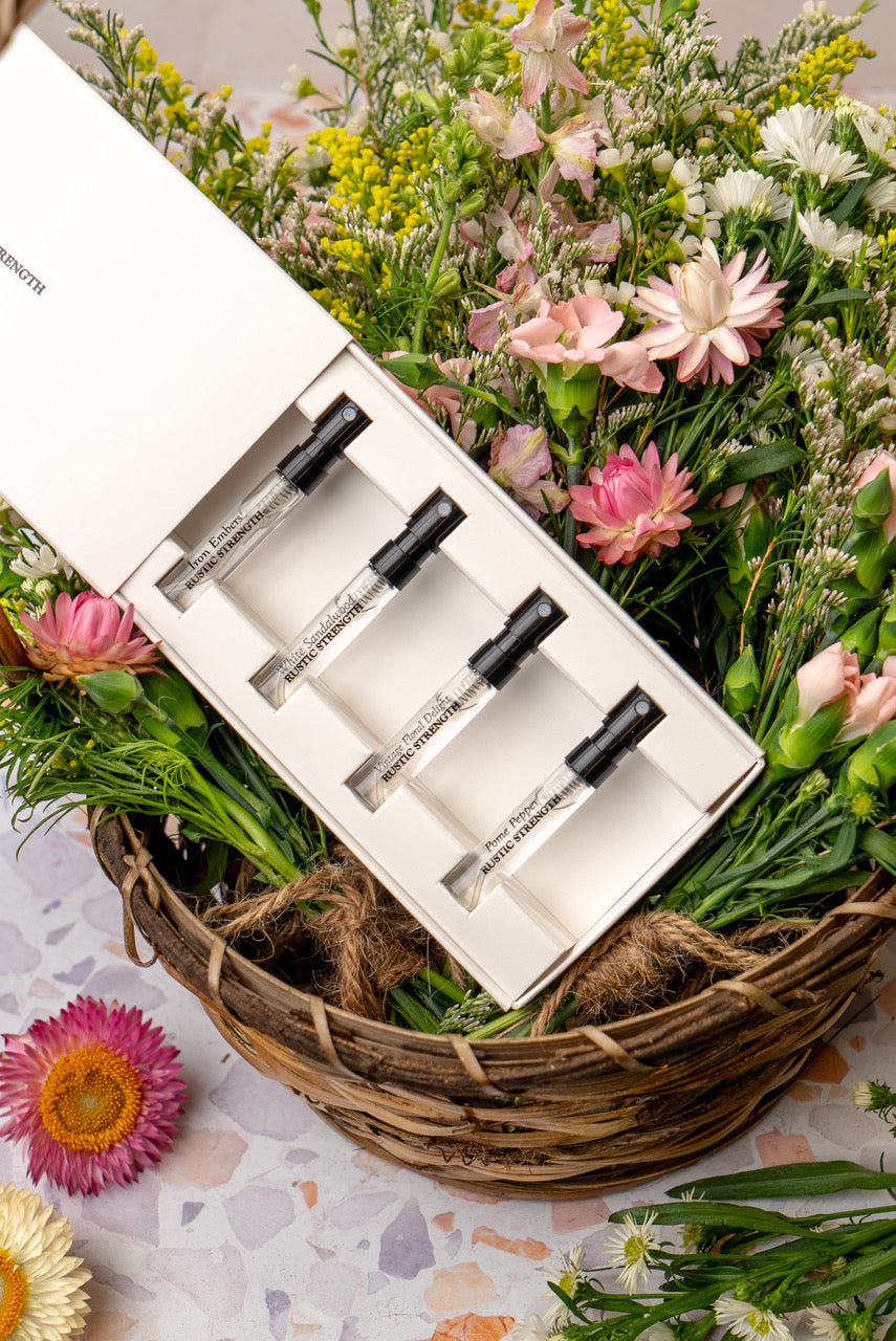 Rustic Strength perfume sample pack with four variety scent vials, showcasing different fragrances in small glass bottles.