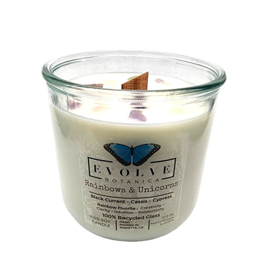 Rainbows and unicorns design on a soy candle with rainbow fluorite gemstone and wooden wick, by Evolve Botanica.