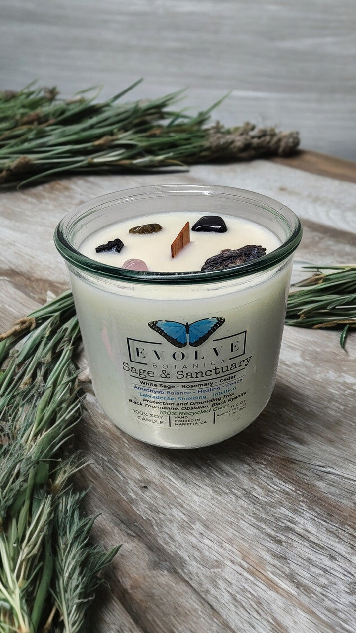 Rocks Candle by Evolve Botanica featuring sage, black kyanite, tourmaline, obsidian, amethyst, and labradorite stones.