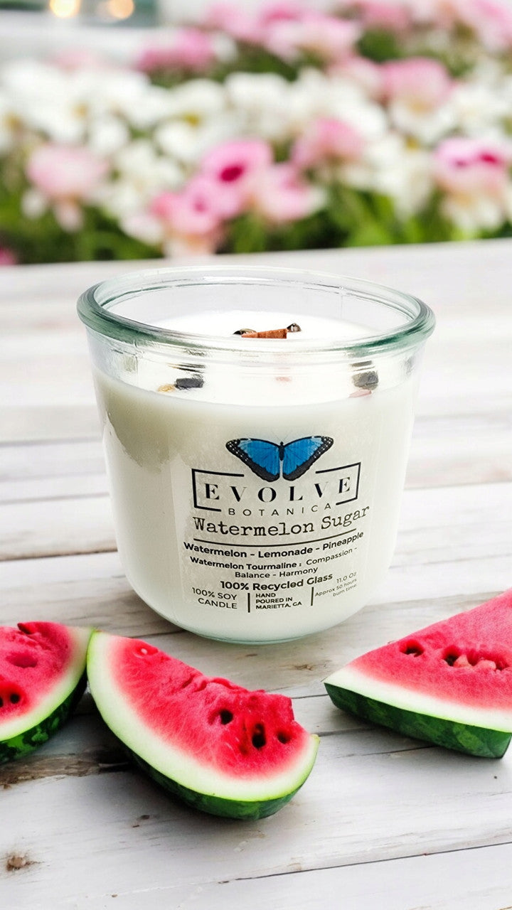 Watermelon Sugar gemstone soy candle with wood wick by Evolve Botanica, featuring vibrant pink and green wax with a gemstone design.
