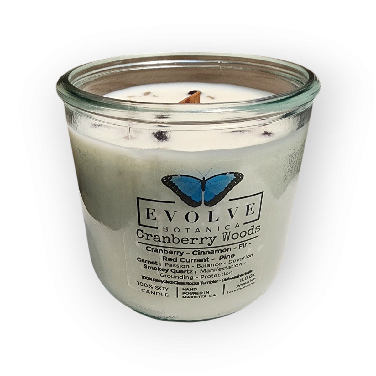 Evolve Botanica Rocks Candle Cranberry Woods soy candle with wood wick, garnet and smoky quartz gemstones, burning softly.