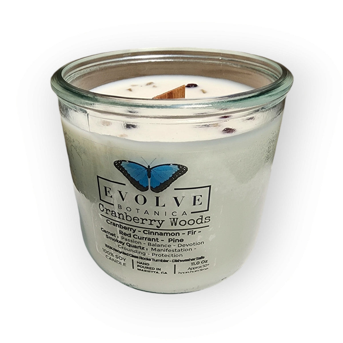 Evolve Botanica Rocks Candle Cranberry Woods soy candle with wood wick, garnet and smoky quartz gemstones, in a decorative glass jar.