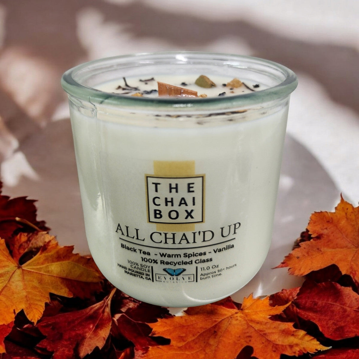 Evolve Botanica Rocks Candle Chai with wood wick, gemstone soy candle in a glass jar, warm and inviting aesthetic.