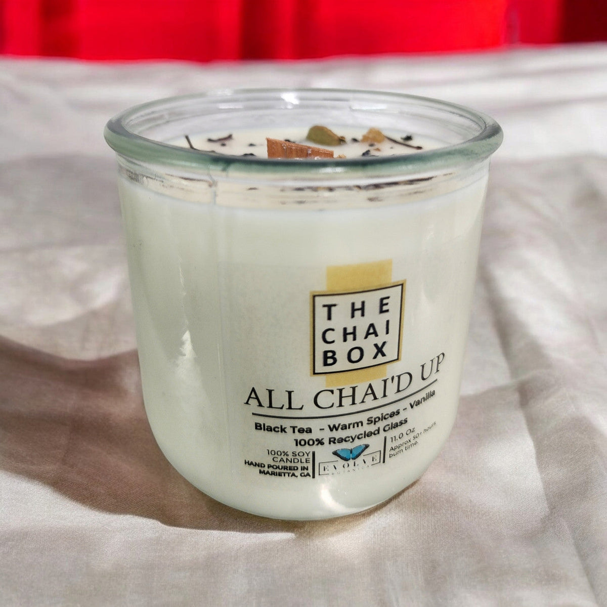 Evolve Botanica Rocks Candle Chai with wood wick and gemstone, soy wax in a decorative glass container, cozy and aromatic.
