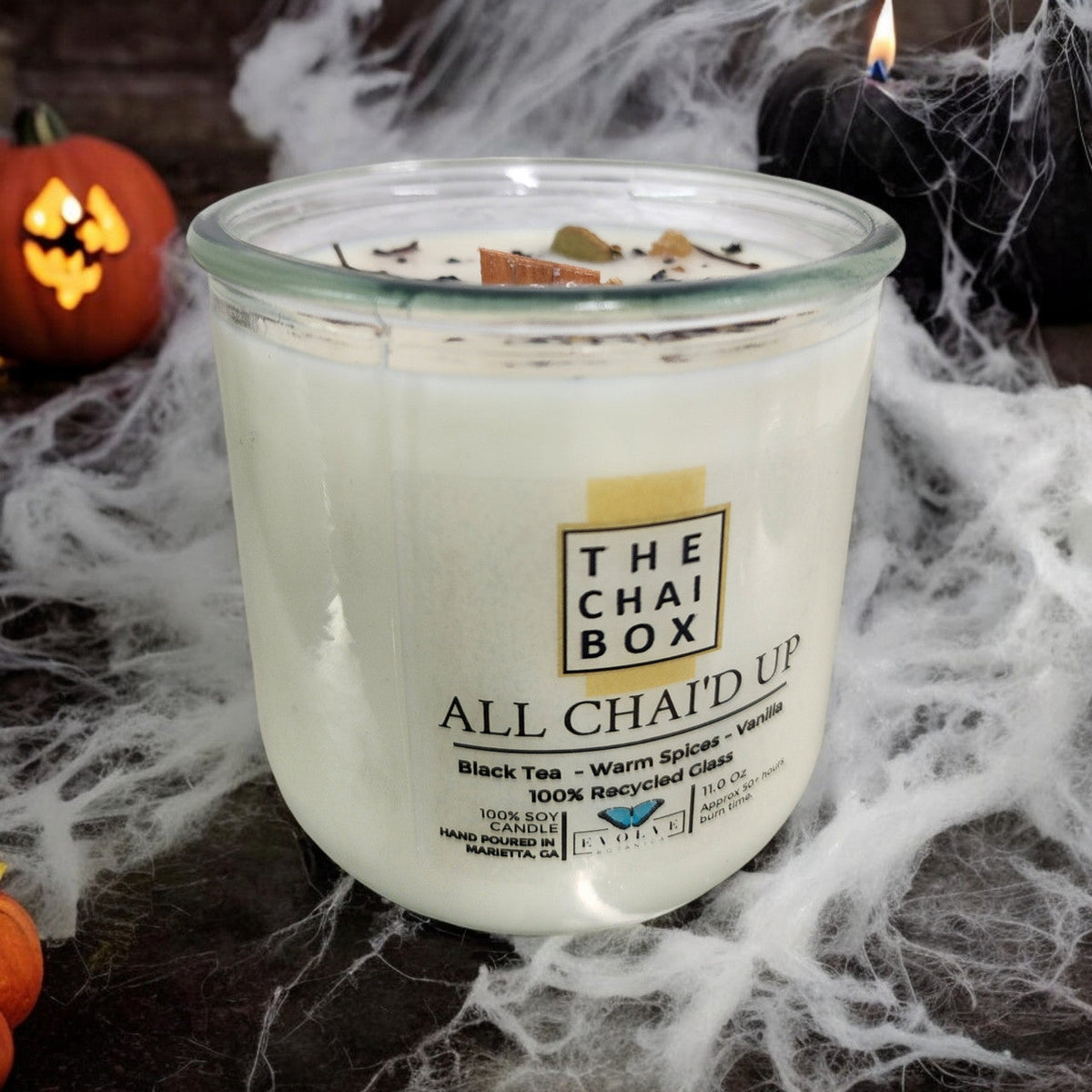 Evolve Botanica Rocks Candle Chai with wooden wick and gemstone accents, soy wax in a clear glass container.