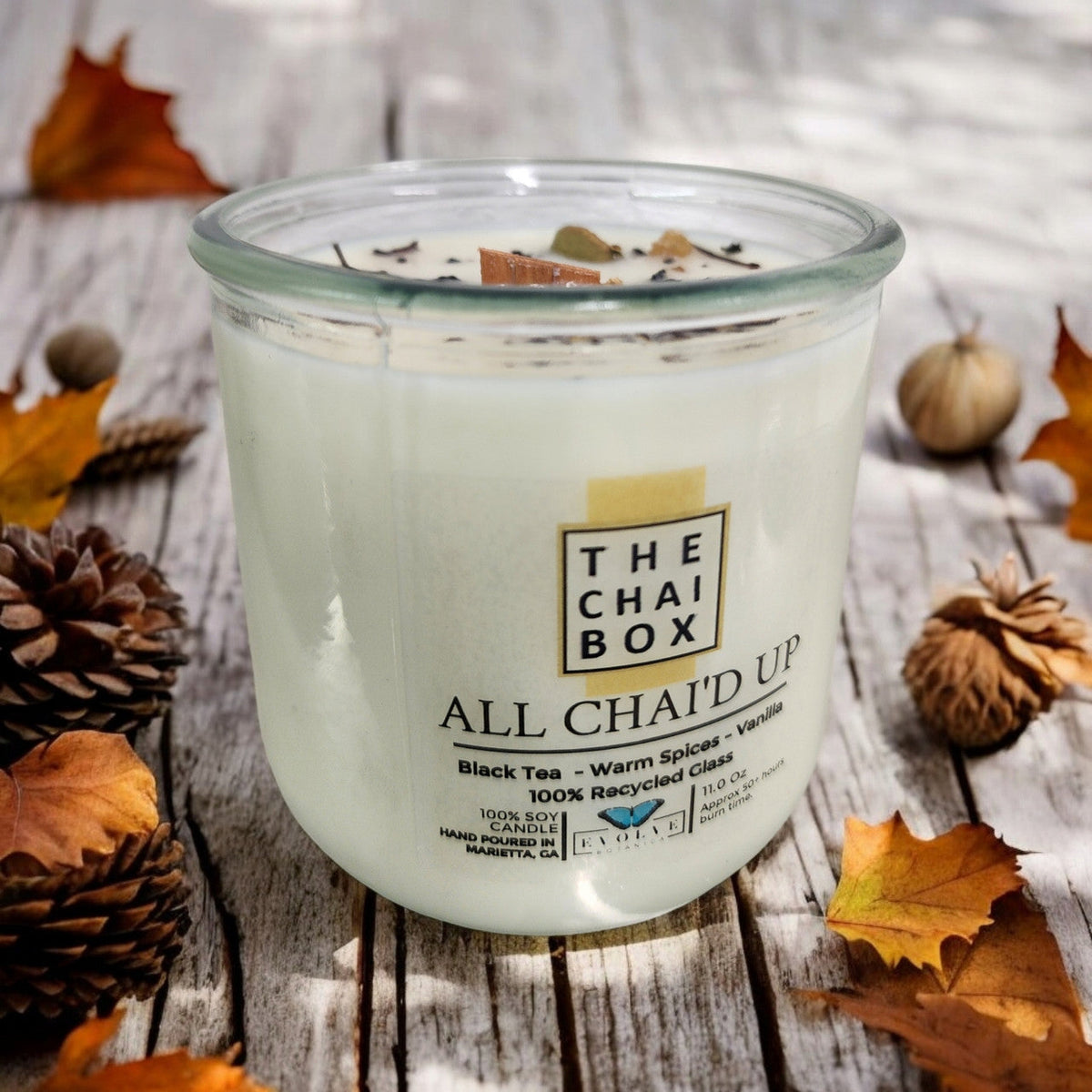 Evolve Botanica Rocks Candle Chai soy candle with wood wick and gemstone accents, creating a warm, calming ambiance.