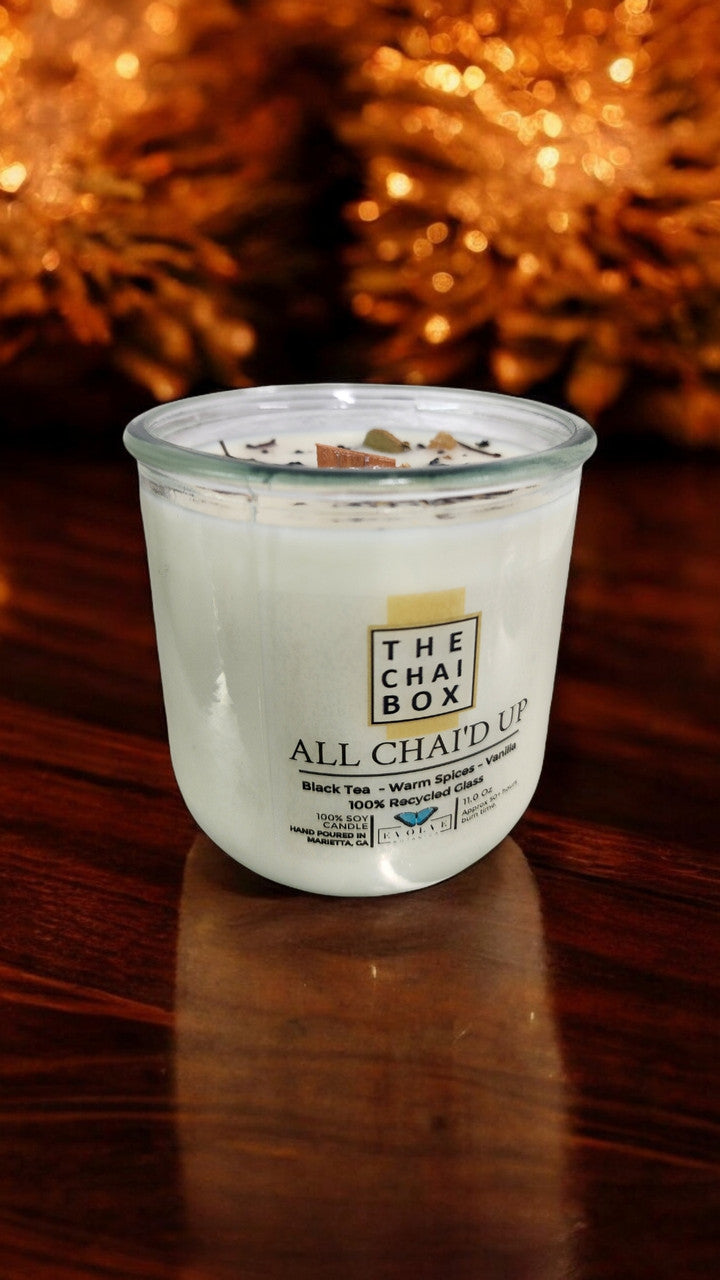 Evolve Botanica Rocks Candle Chai with wood wick and gemstone, soy wax in a decorative jar, burning softly for a cozy ambiance.