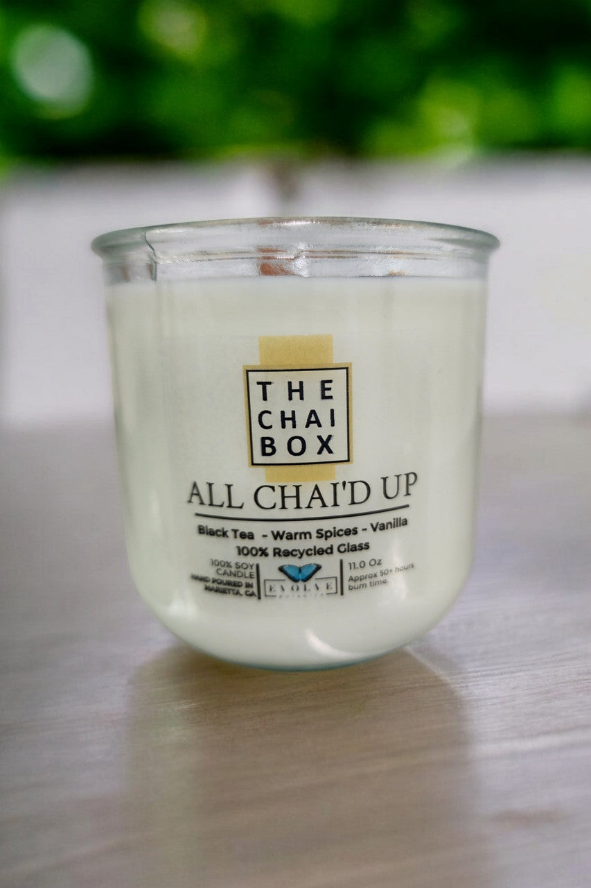 Evolve Botanica Rocks Candle Chai with wood wick and gemstone soy candle in a glass jar, emitting a warm, cozy glow.