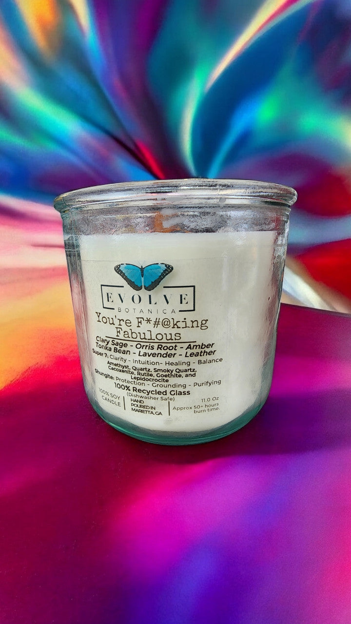 Evolve Botanica Rocks Candle with amethyst, quartz, smoky quartz, cacoxenite, rutile, goethite, and lepidocrocite crystals in a candle holder