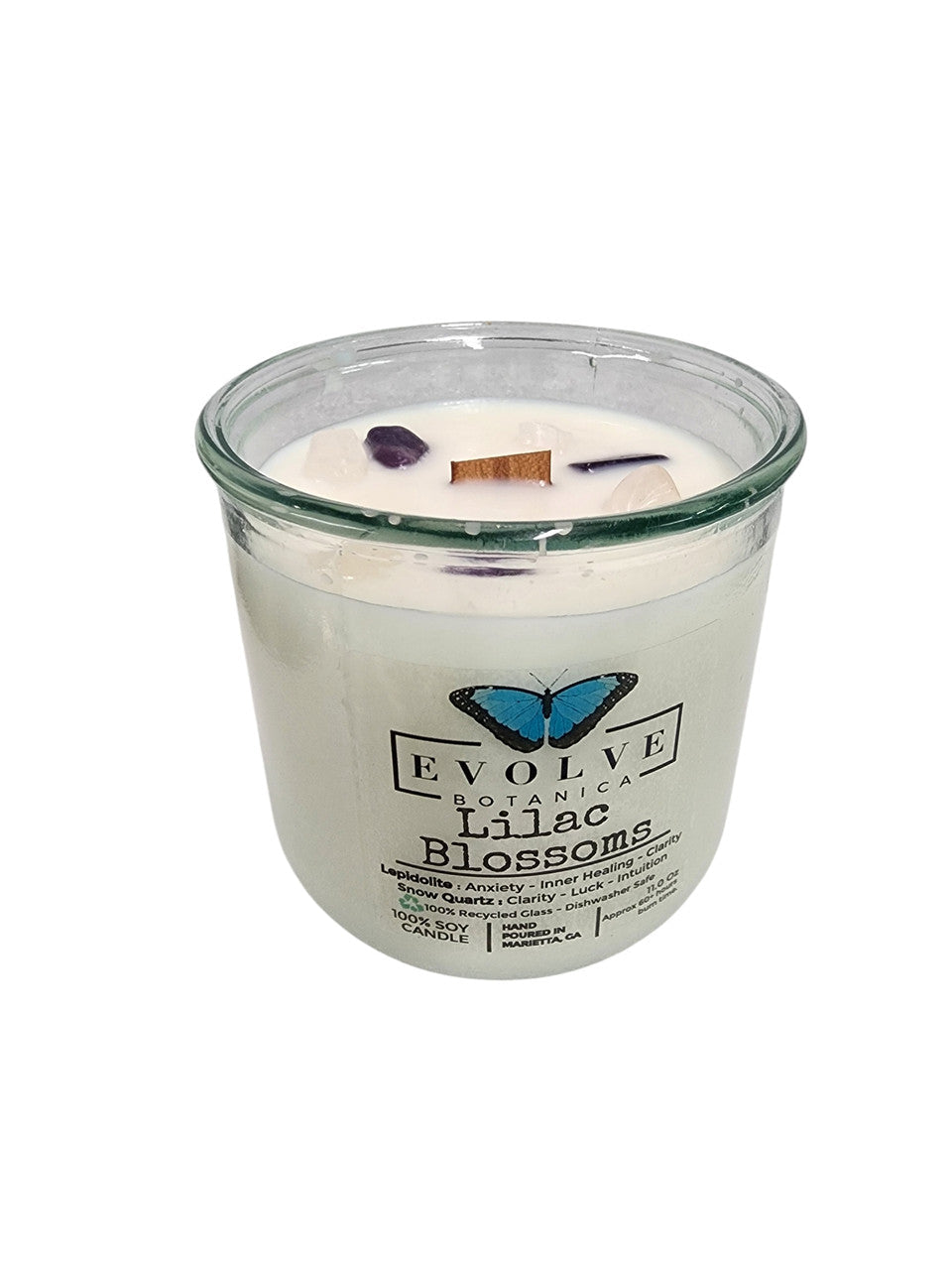 Evolve Botanica Rocks Candle with Lilac Blossoms, wood wick, and Lepidolite gemstone in a soy candle container.