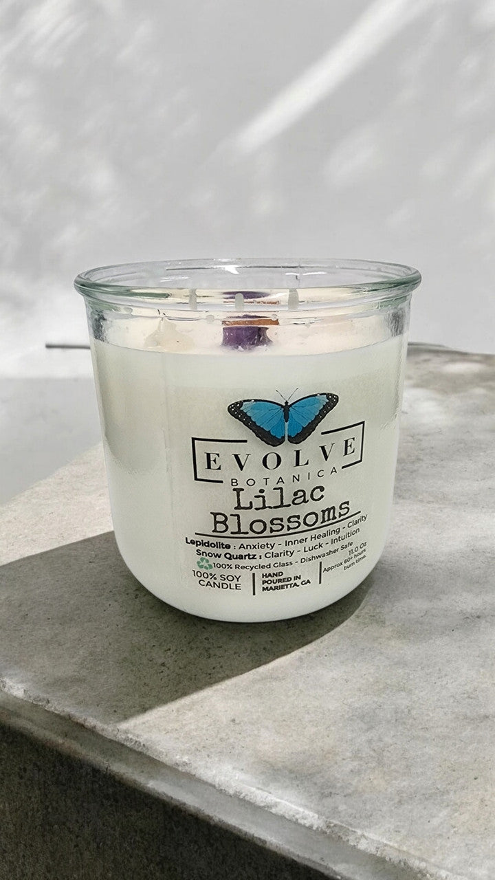 Evolve Botanica Rocks Candle Lilac Blossoms soy candle with wood wick and lepdiolite gemstone, featuring purple and lilac floral design.