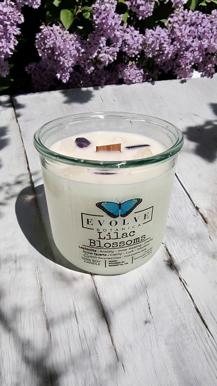 Evolve Botanica Rocks Candle Lilac Blossoms soy candle with wood wick and Lepidolite gemstone, showcasing a serene floral design.