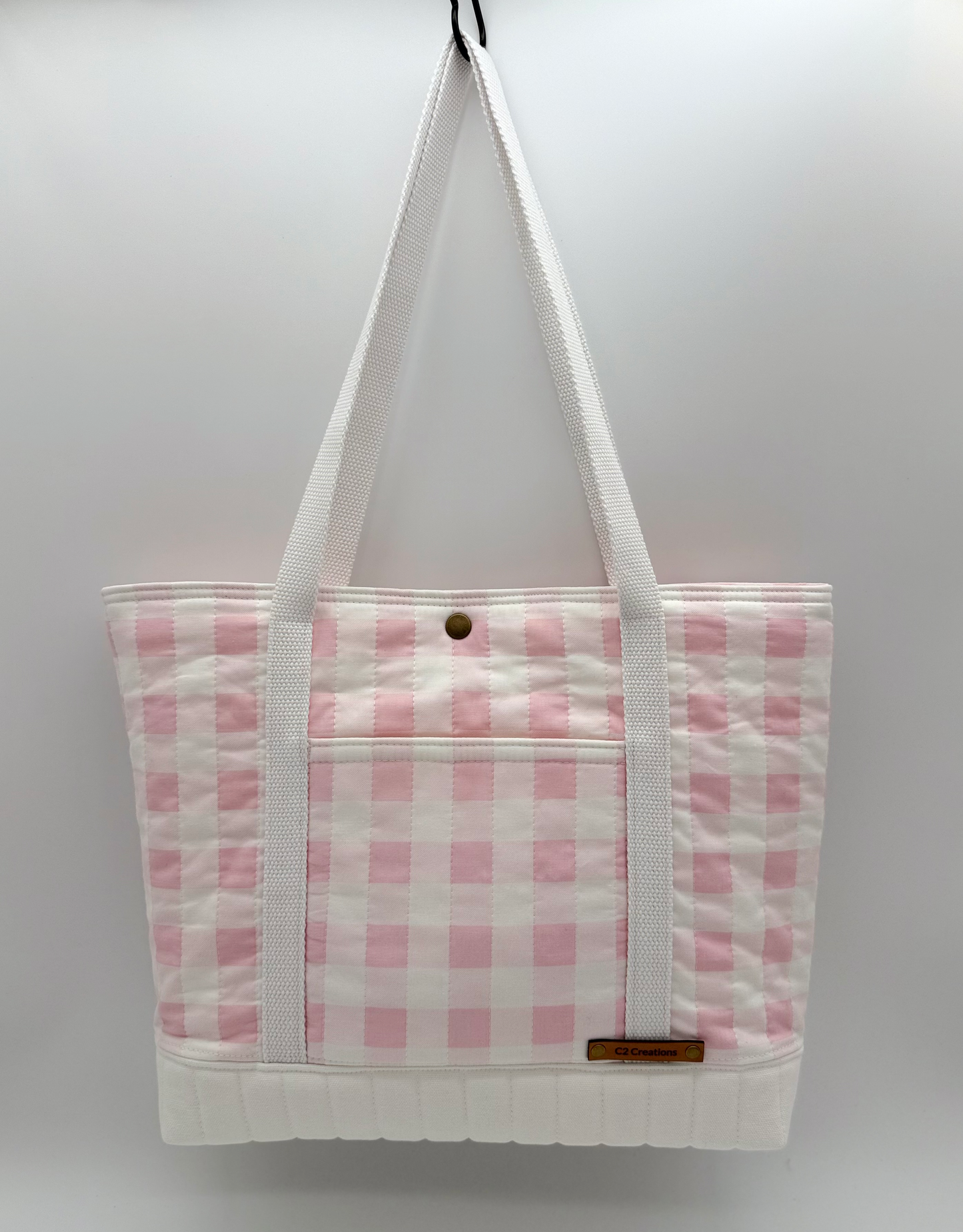 Pink gingham quilted tote bag by C2 Creations LLC featuring handmade canvas with snap closure and front design.