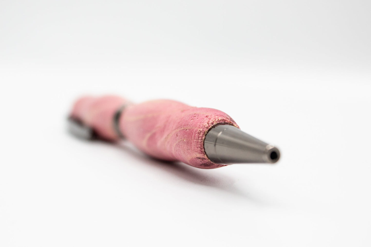 Handcrafted pink stained wood pen from BuyNebraska.com, featuring smooth finish and elegant design, perfect for home and garden use.
